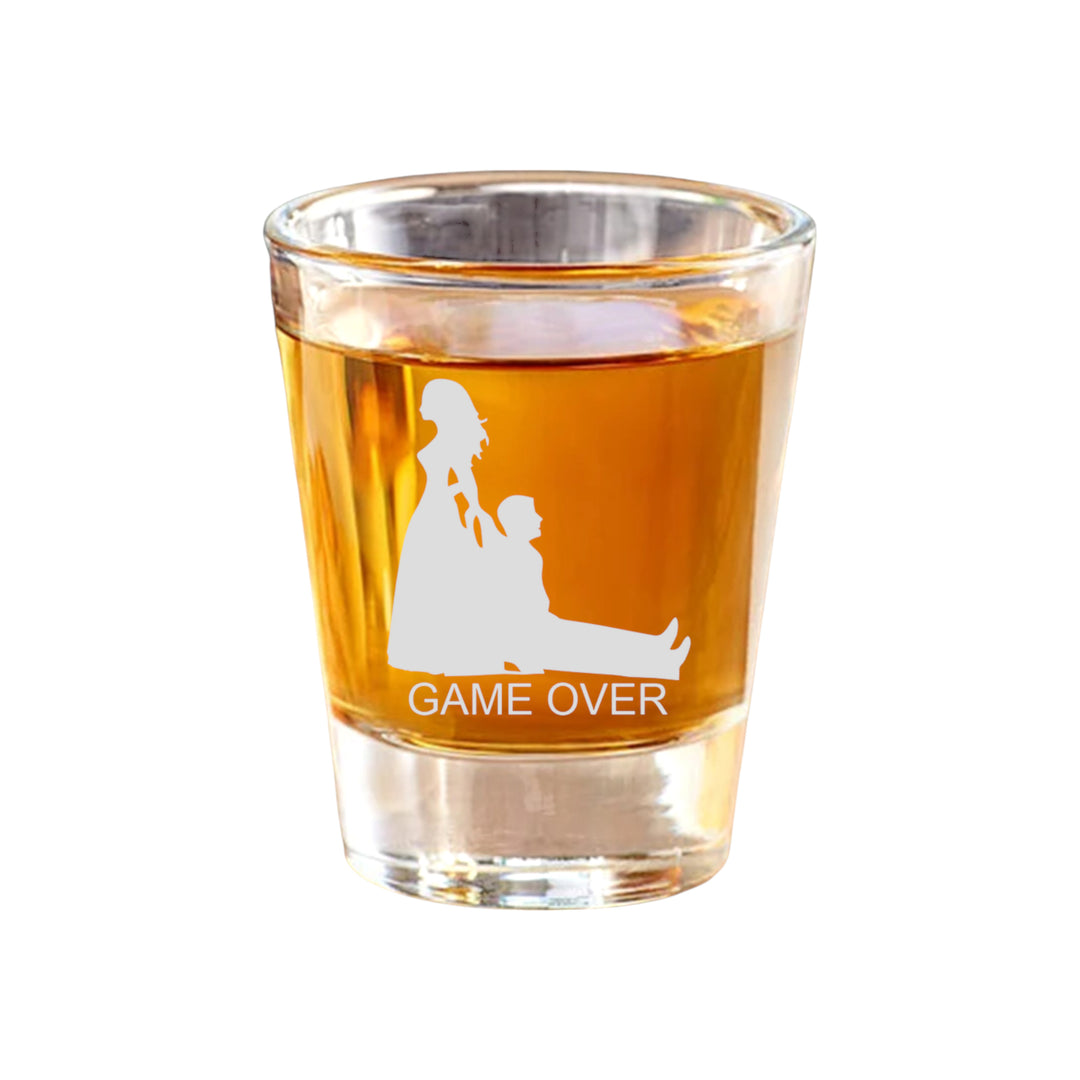 HipFlaskPlus 2oz shot glass filled with whiskey, engraved with a bride dragging a groom and Game Over