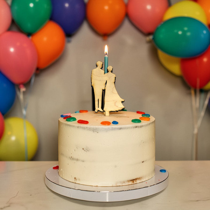 HipFlaskPlus raw maple wood cake topper cut out with a bride and groom on a cake with colorful balloons