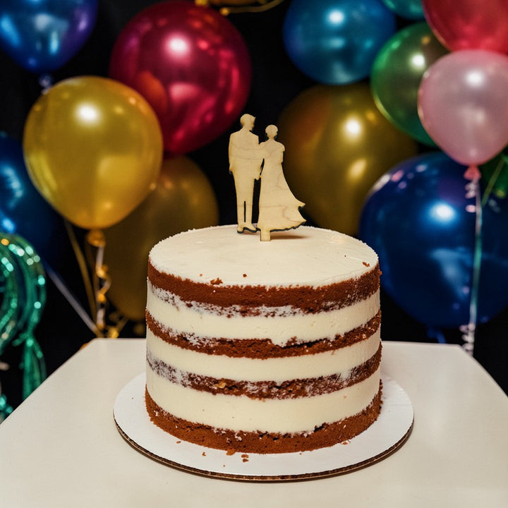 HipFlaskPlus raw maple wood cake topper cut out with a bride and groom on a cake with colorful balloons