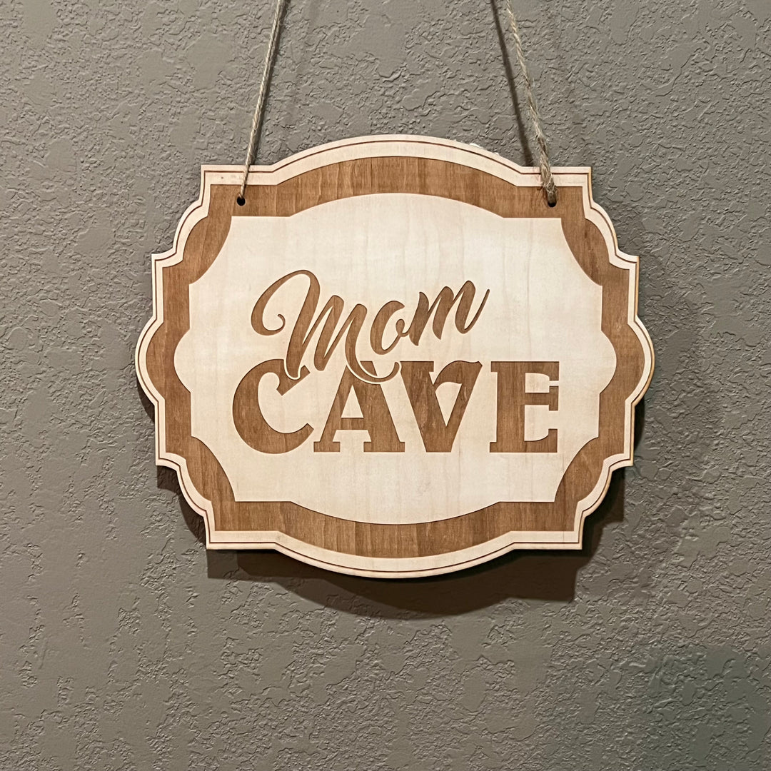 HipFlaskPlus Mom Cave raw wood door sign hanging on rustic wood