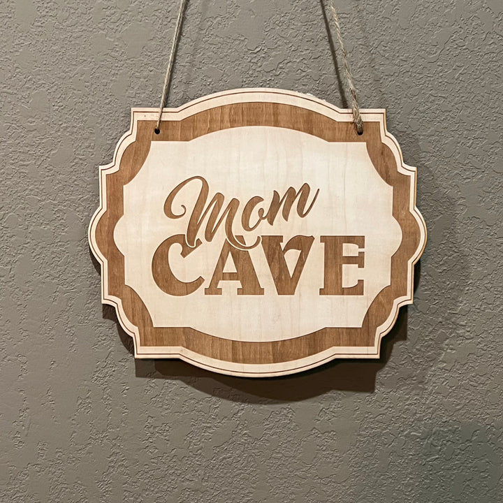 HipFlaskPlus Mom Cave raw wood door sign hanging on rustic wood